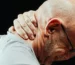 MAN HOLDING HIS NECK IN PAIN AFTER A CAR ACCIDENT WHIPLASH